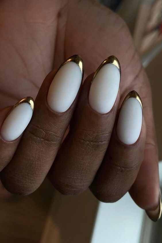 cream matte base manicure with metallic accents