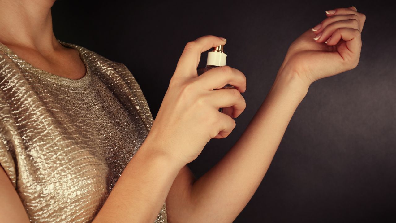 woman testing perfume on wrist